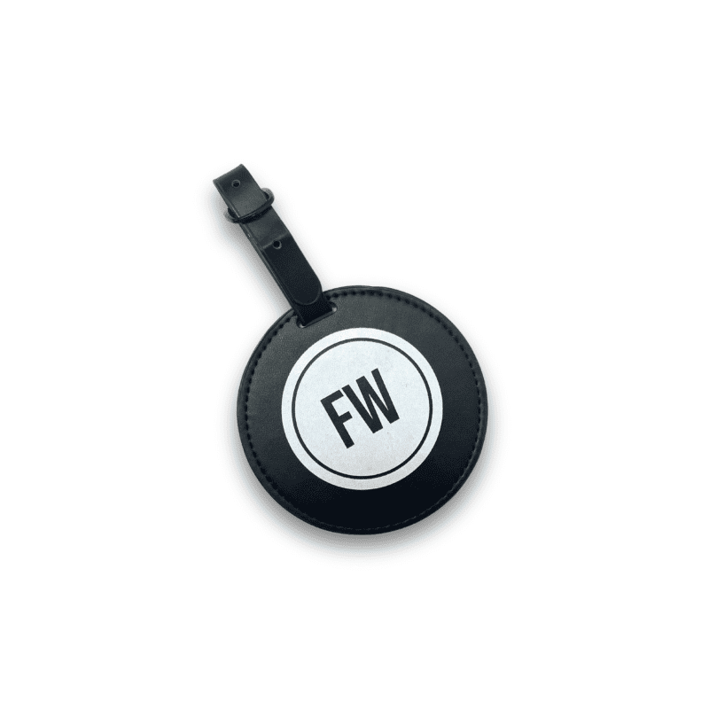 Black circular luggage tag with 'FW' initials